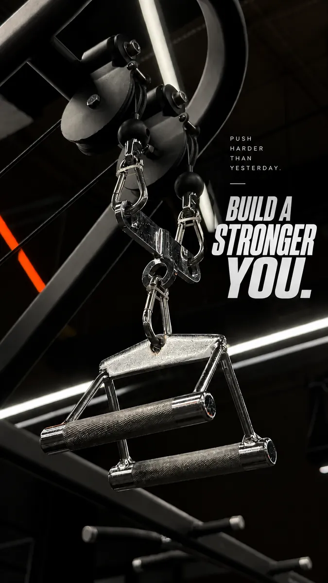 Strength-training cable attachment in a dramatic black gym